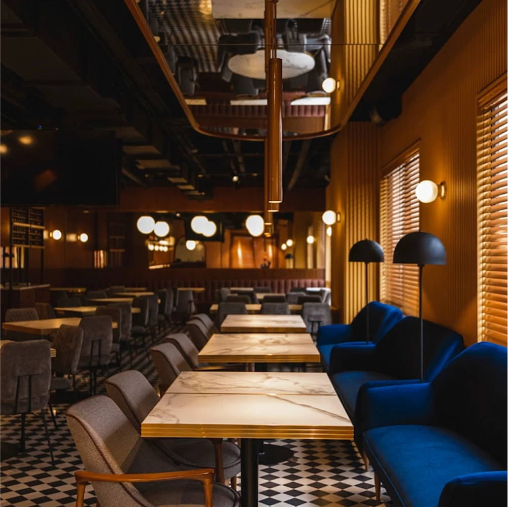 Dunya Lounge interior with marble tables, velvet seating and checkered floors