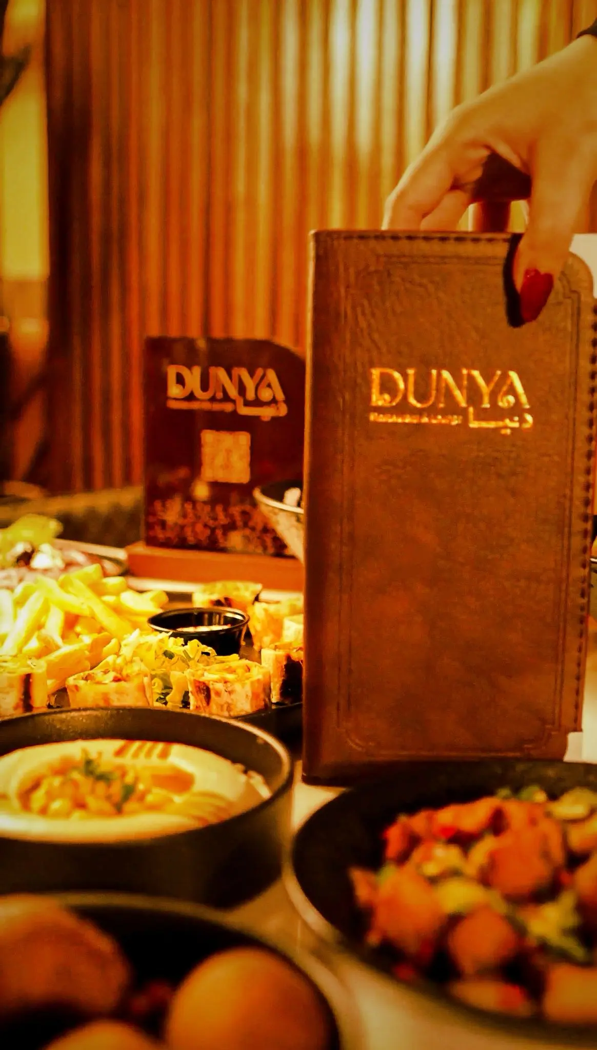 Dunya Lounge gold-stamped leather menu with Levantine dishes
